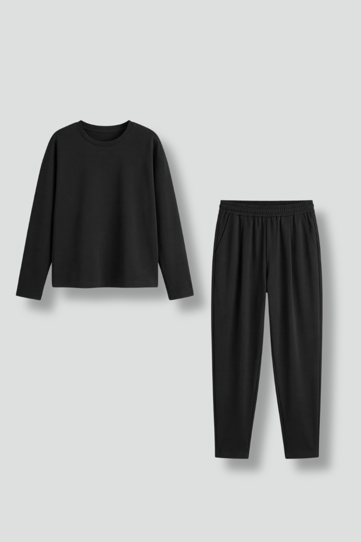 Women’s black two-piece set by THE WHITMORE FAMILY featuring a crew neck top and tapered trousers, styled together.