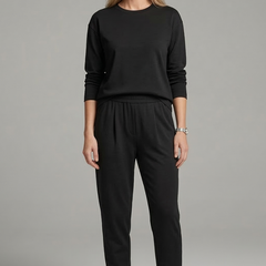Women’s black two-piece set with crew neck top and tapered trousers from THE WHITMORE FAMILY, styled on a model.