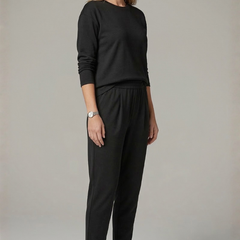 Women’s black two-piece set from THE WHITMORE FAMILY with a crew neck top and tapered trousers, styled for casual wear.