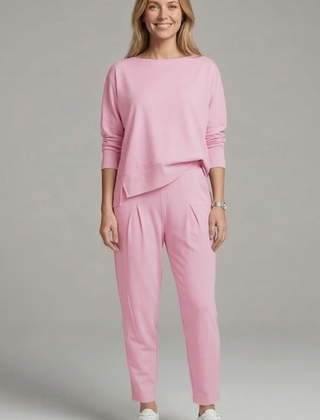 Women’s black two-piece set with crew neck top and tapered trousers by THE WHITMORE FAMILY, shown on a model.