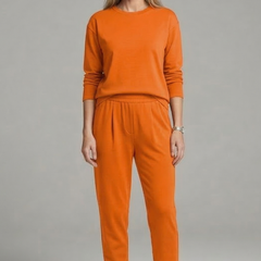 Women’s black two-piece set by THE WHITMORE FAMILY, featuring a crew neck top and tapered trousers, styled for casual wear.