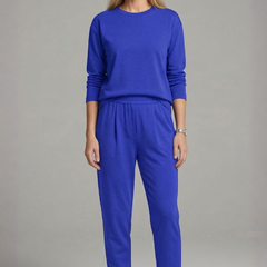 Women’s black two-piece set by THE WHITMORE FAMILY featuring a crew neck top and tapered trousers, displayed on a model.