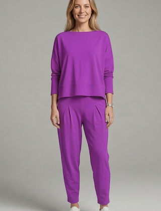 Women’s black two-piece set with crew neck top and tapered trousers by THE WHITMORE FAMILY, shown on a model.