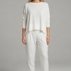 Women's black two-piece set with crew neck top and tapered trousers from THE WHITMORE FAMILY, shown on a model.