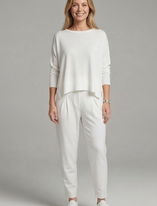 Women's black two-piece set with crew neck top and tapered trousers from THE WHITMORE FAMILY, shown on a model.