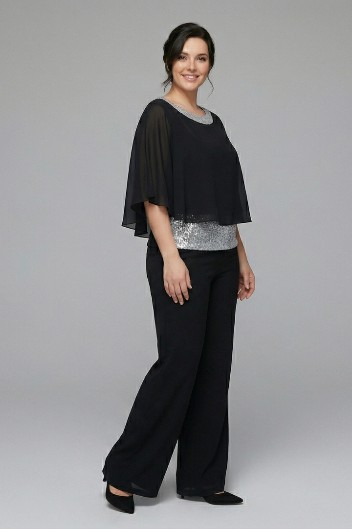 Women’s two-piece set by THE WHITMORE FAMILY featuring an embellished neckline and wide-leg trousers, shown on a model.