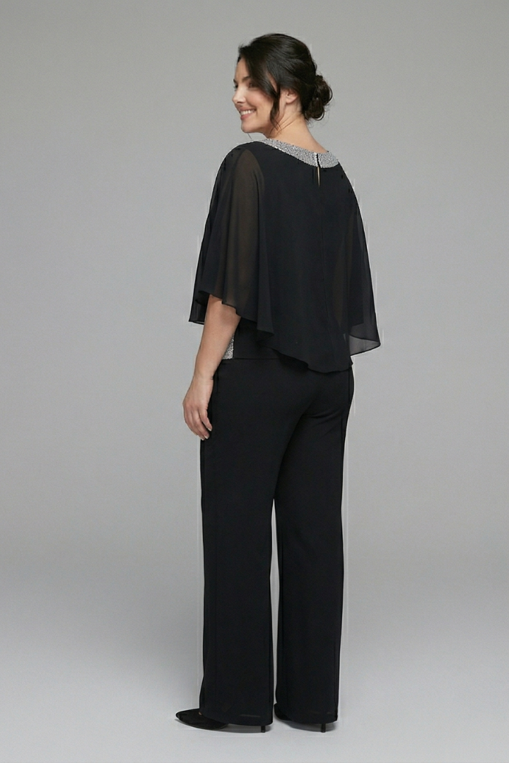 Women’s black two-piece set with embellished neckline and wide-leg trousers by THE WHITMORE FAMILY, shown on a model.