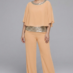 Women’s black two-piece set with embellished neckline and wide-leg trousers by THE WHITMORE FAMILY, shown on a model.