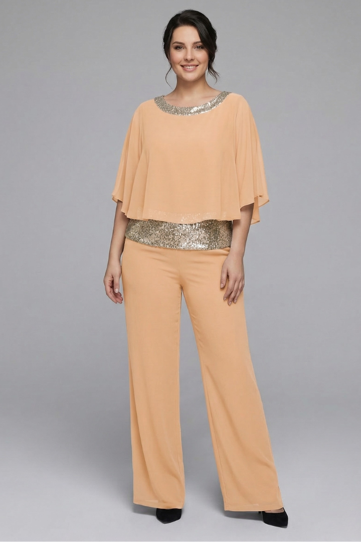 Women’s black two-piece set with embellished neckline and wide-leg trousers by THE WHITMORE FAMILY, shown on a model.