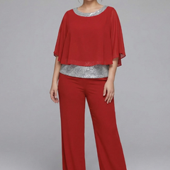 Women’s black two-piece set with embellished neckline and wide-leg trousers by THE WHITMORE FAMILY, displayed on a model.