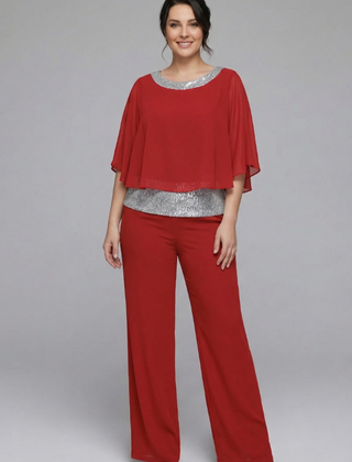 Women’s black two-piece set with embellished neckline and wide-leg trousers by THE WHITMORE FAMILY, displayed on a model.