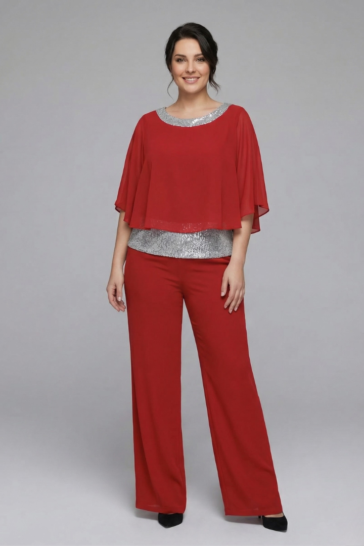 Women’s black two-piece set with embellished neckline and wide-leg trousers by THE WHITMORE FAMILY, displayed on a model.