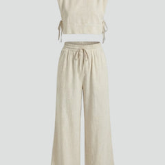 Women’s cream two-piece set by THE WHITMORE FAMILY featuring a sleeveless top and wide-leg pants, casual and stylish.