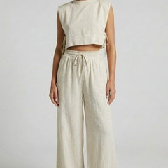 Women's cream two-piece set by THE WHITMORE FAMILY featuring sleeveless top and wide-leg pants, casual and stylish outfit.