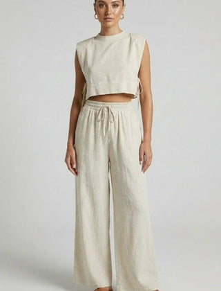Women's cream two-piece set by THE WHITMORE FAMILY featuring sleeveless top and wide-leg pants, casual and stylish outfit.