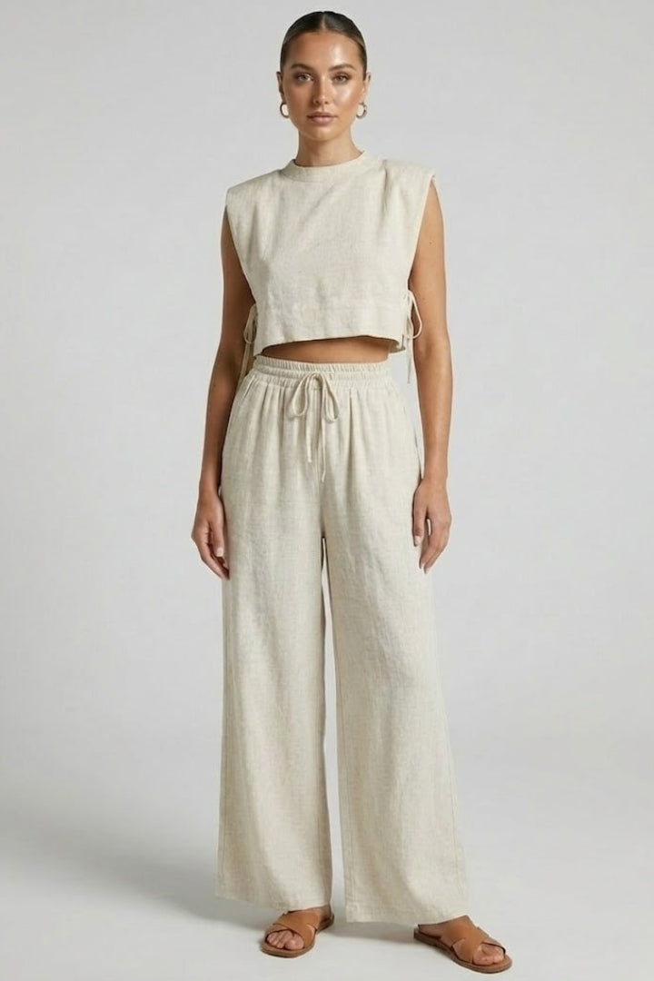 Women's cream two-piece set by THE WHITMORE FAMILY featuring sleeveless top and wide-leg pants, casual and stylish outfit.