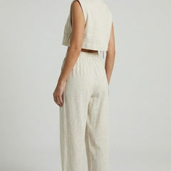 Cream women's two-piece set by THE WHITMORE FAMILY featuring a sleeveless top and wide-leg pants.