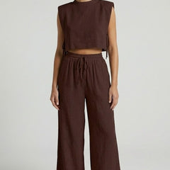 Women's cream two-piece set by THE WHITMORE FAMILY with sleeveless top and wide-leg pants, casual and stylish outfit.