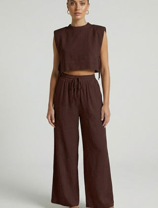 Women's cream two-piece set by THE WHITMORE FAMILY with sleeveless top and wide-leg pants, casual and stylish outfit.