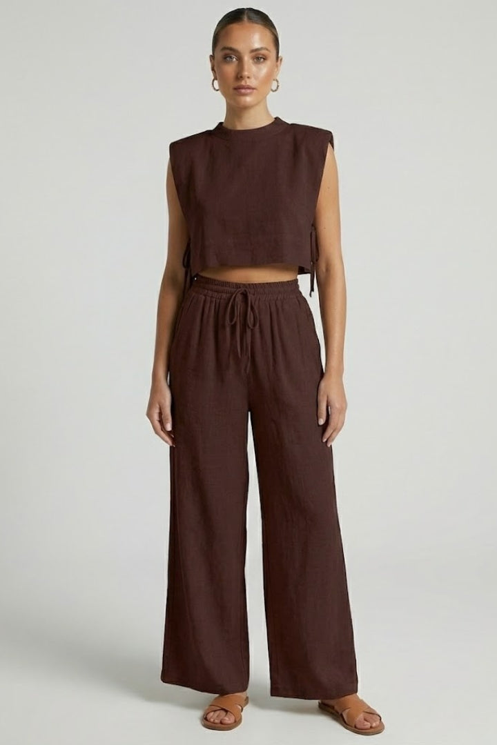 Women's cream two-piece set by THE WHITMORE FAMILY with sleeveless top and wide-leg pants, casual and stylish outfit.