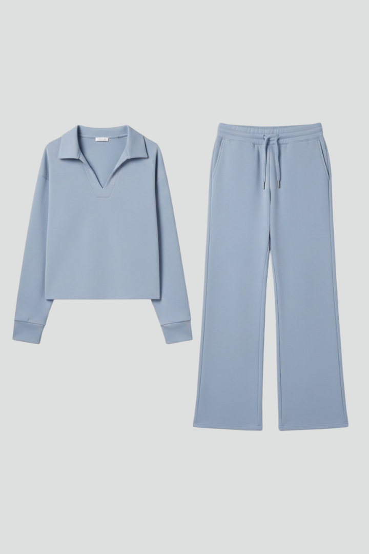 Women’s two-piece set with V-neck top and wide-leg pants from THE WHITMORE FAMILY, shown in a casual indoor setting.
