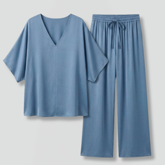 Women’s two-piece trousers set by THE WHITMORE FAMILY featuring black wide-leg pants and a V-neck top.