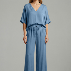 Women’s two-piece trousers set by THE WHITMORE FAMILY featuring black wide-leg pants and a V-neck top, perfect for stylish casual wear.