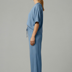 Women's two-piece trousers set by THE WHITMORE FAMILY featuring a V-neck top and wide-leg pants in black.