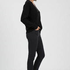 Women’s V-neck sweater with long sleeves and pullover style by THE WHITMORE FAMILY, shown in a cozy, knit fabric.