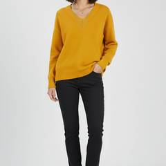 Women’s V-neck sweater with long sleeves and pullover design by THE WHITMORE FAMILY, shown in a cozy knit style.