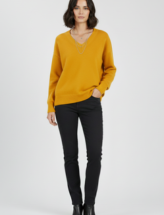 Women’s V-neck sweater with long sleeves and pullover design by THE WHITMORE FAMILY, shown in a cozy knit style.