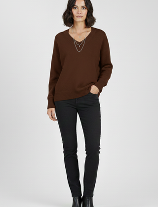 Women's V-neck sweater with long sleeves and pullover design by THE WHITMORE FAMILY, featuring a cozy knit fabric in a classic style.
