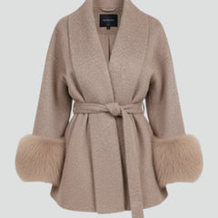 Beige women's belted full-length coat with waist tie from THE WHITMORE FAMILY, showcasing a stylish jacket with a classic silhouette.