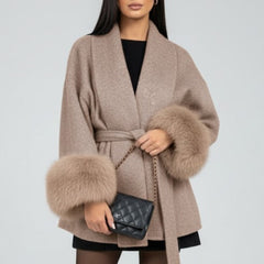 Beige women's belted full-length coat with waist tie from THE WHITMORE FAMILY, stylish winter jacket for women.