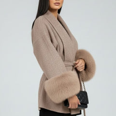 Beige women's belted full-length coat with waist tie from THE WHITMORE FAMILY, featuring a stylish jacket design.