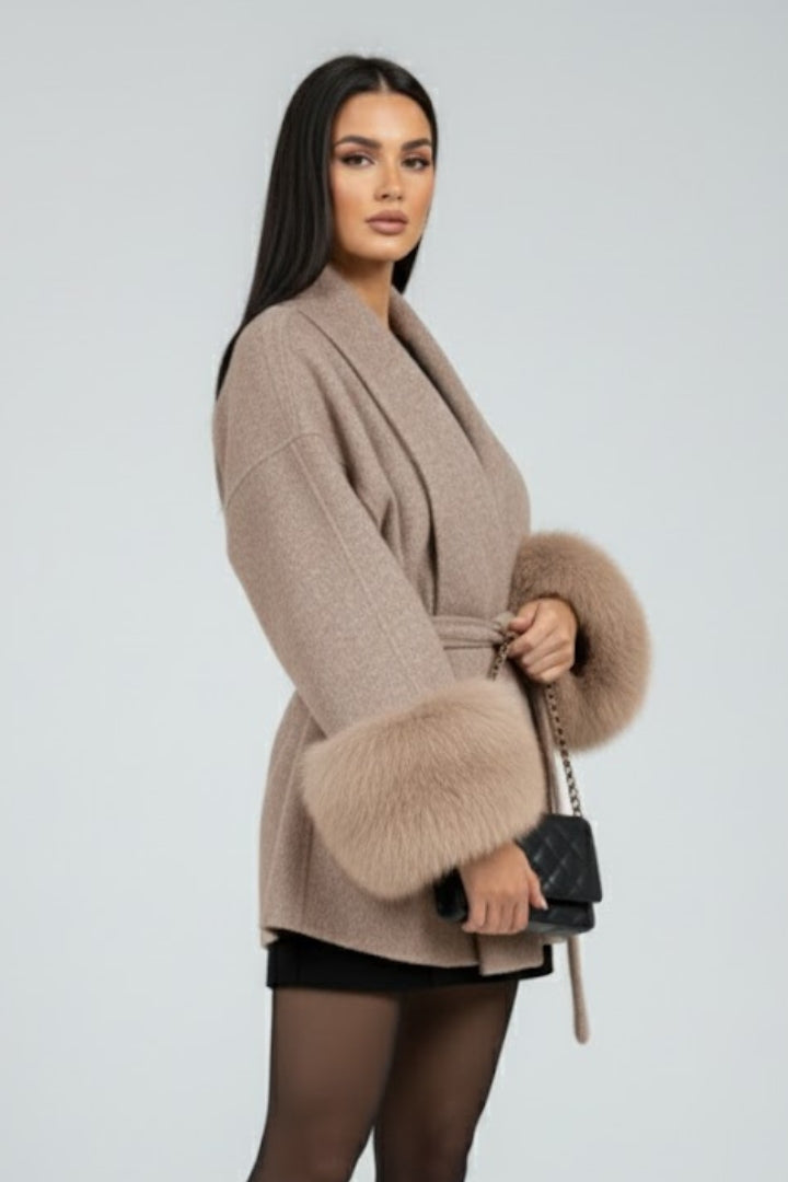 Beige women's belted full-length coat with waist tie from THE WHITMORE FAMILY, featuring a stylish jacket design.