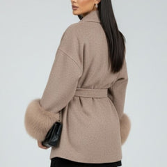 Beige women’s full-length coat with belt and waist tie by THE WHITMORE FAMILY, showcasing a stylish and warm winter jacket.
