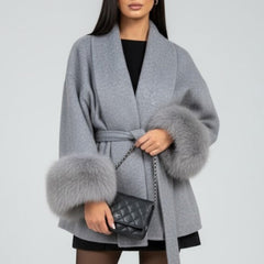Beige women's full-length coat with waist tie and belt from THE WHITMORE FAMILY, shown with a front view and stylish design.
