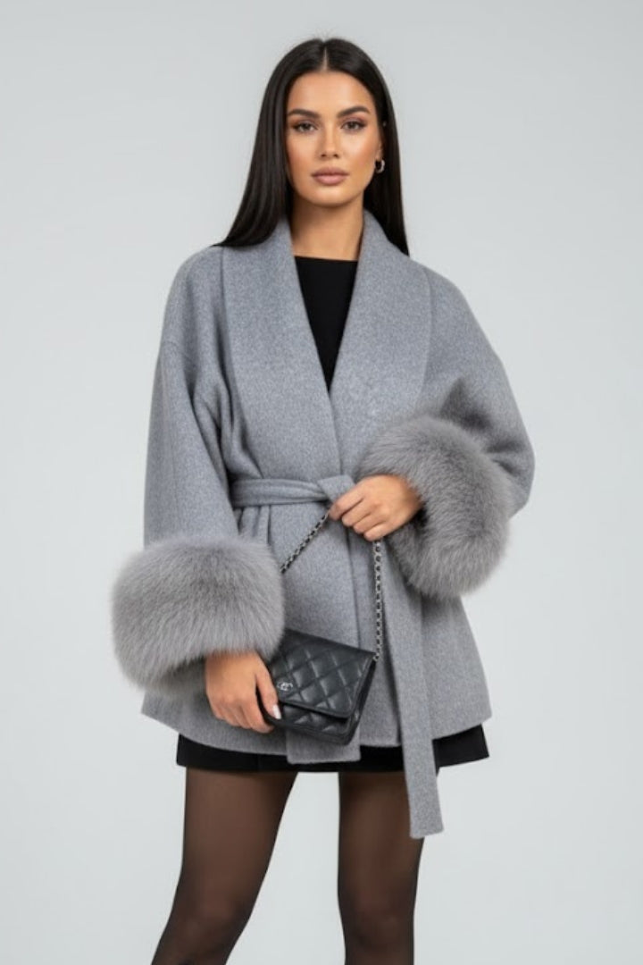 Beige women's full-length coat with waist tie and belt from THE WHITMORE FAMILY, shown with a front view and stylish design.