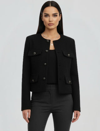 Black women's cropped jacket with button front from THE WHITMORE FAMILY, styled with a fitted silhouette and long sleeves.