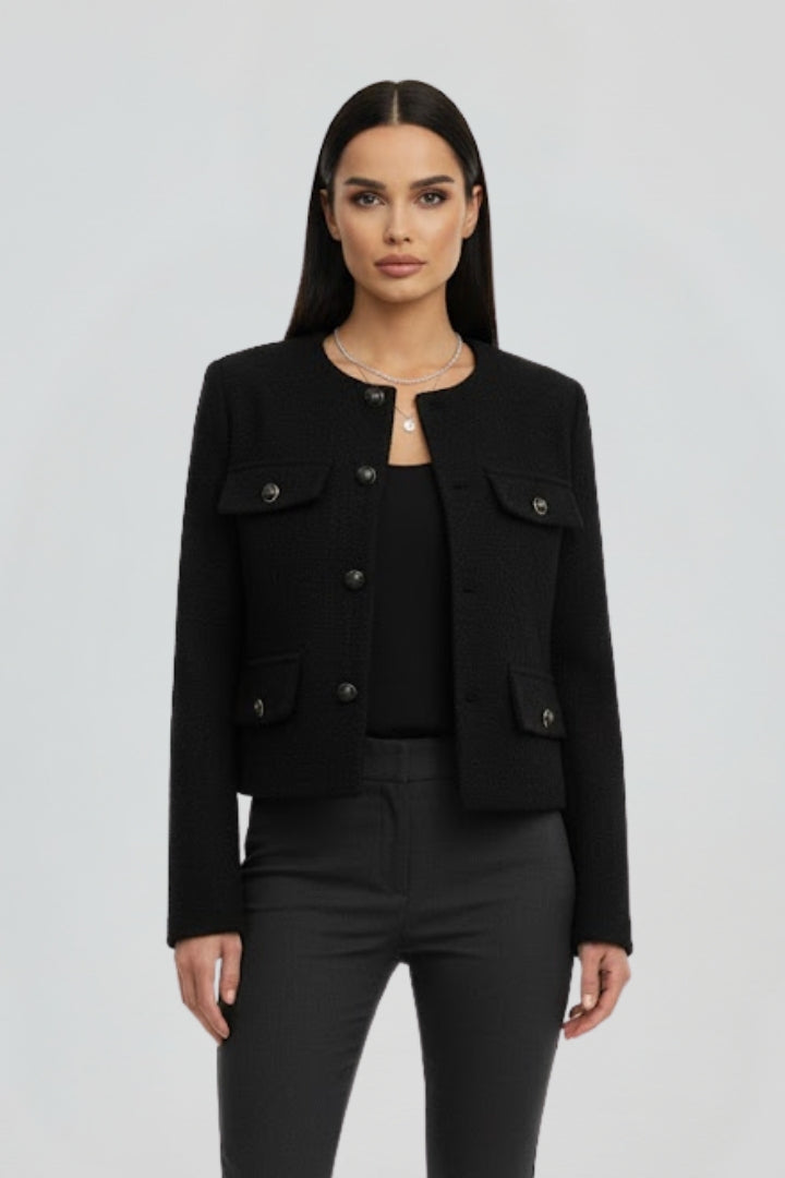 Black women's cropped jacket with button front from THE WHITMORE FAMILY, styled with a fitted silhouette and long sleeves.