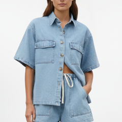 Women’s denim set by THE WHITMORE FAMILY featuring a short-sleeve shirt jacket and matching shorts in subtle blue denim.