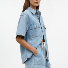 Women’s denim set by THE WHITMORE FAMILY featuring a short-sleeve shirt jacket and matching shorts in subtle blue.