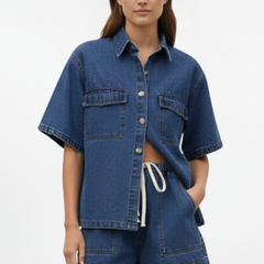 Women’s denim set from THE WHITMORE FAMILY featuring a short-sleeve shirt jacket and matching shorts in subtle blue.