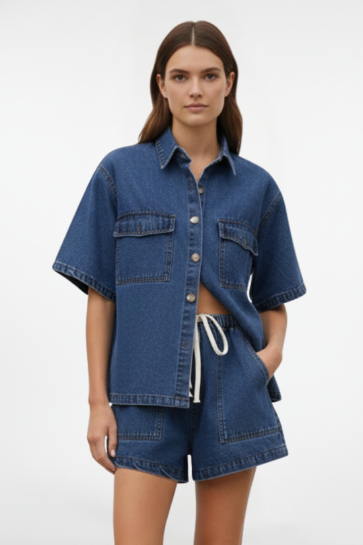 Women’s denim set from THE WHITMORE FAMILY featuring a short-sleeve shirt jacket and matching shorts in subtle blue.