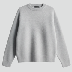Women’s knitted sweater with round neckline and dropped shoulders, by THE WHITMORE FAMILY, shown on a model, casual and cozy style.