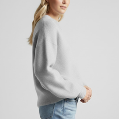 Women’s oversized knitted sweater with round neckline and dropped shoulders, by THE WHITMORE FAMILY, shown in a cozy, relaxed fit.