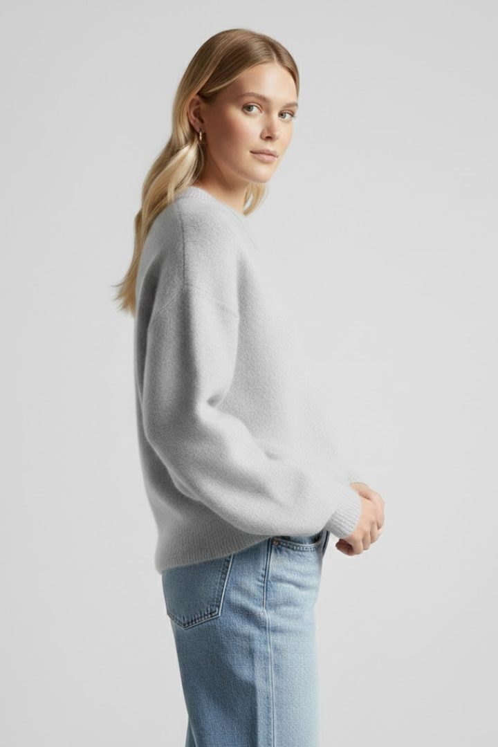 Women’s oversized knitted sweater with round neckline and dropped shoulders, by THE WHITMORE FAMILY, shown in a cozy, relaxed fit.
