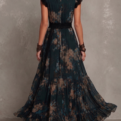 Gillian™ Maxi Dress by THE WHITMORE FAMILY, flowing fabric, sleeveless design, and ankle-length silhouette in a stylish pattern.