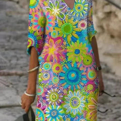 Nira vibrant floral midi dress by THE WHITMORE FAMILY featuring bright yellow fabric and a flowing, elegant design.